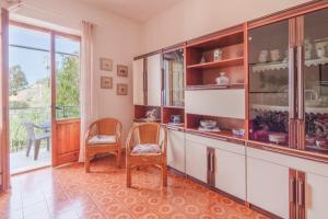 a living room with two chairs and a large window at Casa Fiorella a Pomonte-Goelba in Pomonte