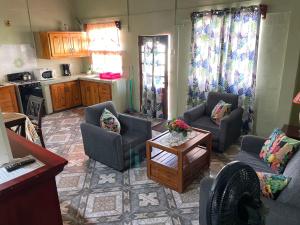 a living room with two couches and a table at Shirvan Holiday Apartments One Bedroom in Canaan