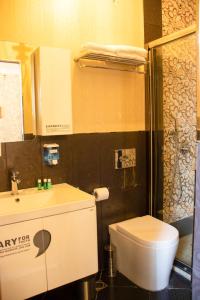 a bathroom with a toilet and a sink and a shower at La Casa Old City Hotel in Baku