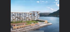 a large apartment building next to a body of water at Ocean view apartment in Tromsø