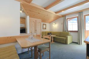 a living room with a table and a couch at Ausserwieserhof in Neustift im Stubaital