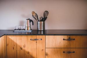 a wooden cabinet with a counter top with utensils at Karlshütte in Avelengo