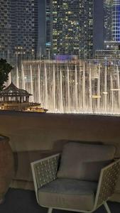 a large water fountain in a room with a chair at ULTIMATE DXB DOWNTOWN PENTHOUSE in Dubai