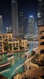 a view of a river in a city at night at ULTIMATE DXB DOWNTOWN PENTHOUSE in Dubai