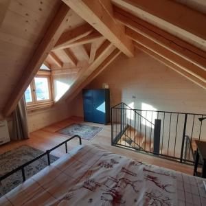 a bedroom with a large bed in a attic at Chalet Ridente con Patio al Gufo in Ovaro