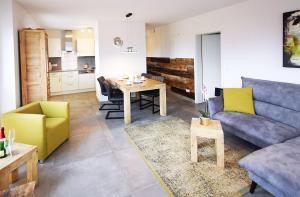 a living room with a blue couch and a table at Baabe Strandvilla - Luxus Ferienwohnung mit Meerblick (Ref. 158481) in Baabe