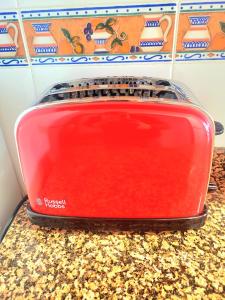 a red toaster sitting on top of a counter at Sea Breeze Apartament in Benicarló