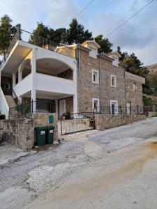 a large brick building on the side of a road at Villa with stunning Mountain Views and Authentic Croatian Stone House near Split and Sea in Žrnovnica
