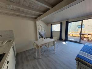 a kitchen and dining room with a table and chairs at La maison du Lac in Doussard