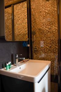 a bathroom with a sink and a shower at La Casa Old City Hotel in Baku