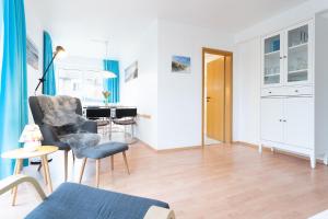 a living room with a chair and a table at Seestraße 56 Wohnung 8 in Scharbeutz