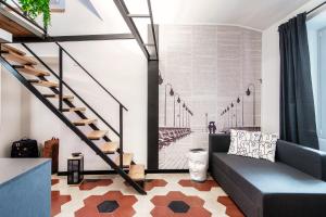 a living room with a staircase and a couch at Casa Dei Viaggiatori - The House Of Travelers in Como