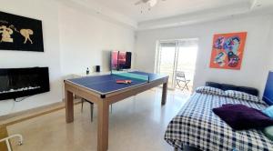 a room with a ping pong table and a bed at Private Room & Ensuite Bathroom In Stylish Shared Apartment - River View, Beach & Lisbon Accesss in Almada