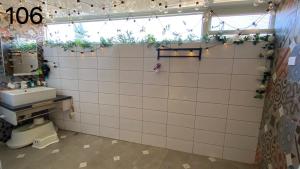 a bathroom with a sink and a tiled wall at Wind Natural Parent-Child Inn II in Houli