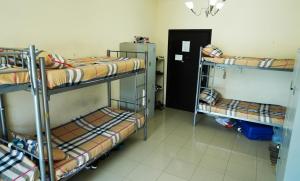 a room with three bunk beds and a doorway at Ladies hostel near Burjuman Metro Station in Dubai