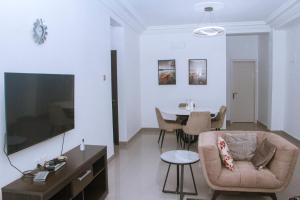 a living room with a couch and a table at Candide Guest House in Limbe