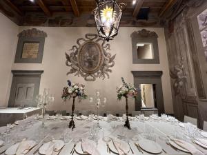uma grande mesa num quarto com um lustre em Nello's, Villa di pregio con SPA em Cortona