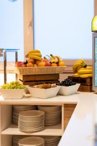 a display of fruits and vegetables in baskets on a shelf at COOEE alpin Hotel Bad Kleinkirchheim in Bad Kleinkirchheim