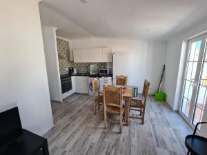 a kitchen and dining room with a table and chairs at Casa 50 in Lagos