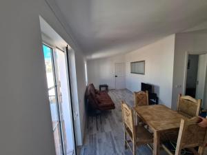 a living room with a dining room table and chairs at casa 50 in Lagos
