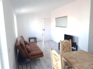 a living room with a leather chair and a table at casa 50 in Lagos