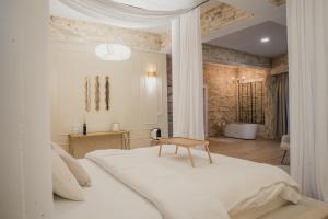 Un dormitorio con una cama blanca con una mesa de madera. en Castle Transylvania en Alba Iulia