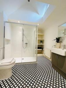 a bathroom with a shower and a toilet and a sink at NEW! Blakeney. Harbour View in Blakeney