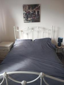 a bedroom with a large bed with a blue blanket at 32 Elder Drive Chester CH4 8PD in Chester