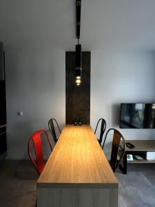 a dining room with a wooden table and chairs at Apartament na Rydlówce in Krakow