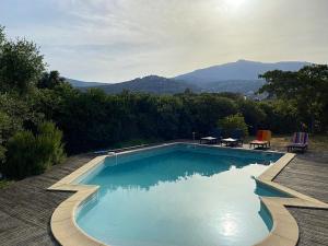 a swimming pool with a view of a mountain at Villa de 4 chambres avec piscine privee jardin clos et wifi a Borgo in Borgo