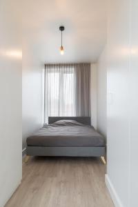 a bedroom with a bed and a window at K50171 Modern apartment near the center and free parking in Eindhoven