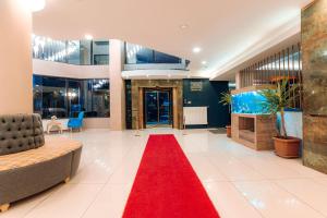 a lobby with a red carpet and a red rug at Aksular Hotel in Trabzon