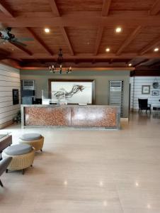 a lobby with a bar with stools and a table at Alleia's Place at Tagaytay in Tagaytay