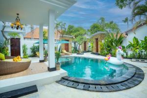 a swimming pool with a rubber duck in a house at Alam Jepun Villa in Legian