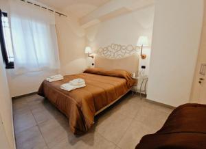 a bedroom with a bed with two towels on it at Casa di fiore bad and breakfast in San Giovanni in Fiore