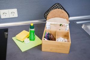 a kitchen counter with a sink with a trash can and a drawer at Old Town Apartments in Berlin