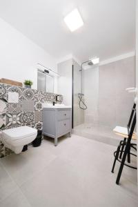 a bathroom with a toilet and a shower and a sink at Old Town Apartments in Berlin