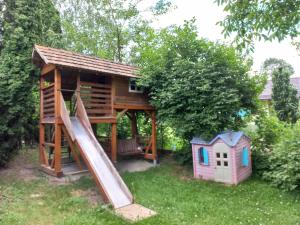 a playground with a slide and a house at Zelena Sadyba Bila Stavka in Yaremche