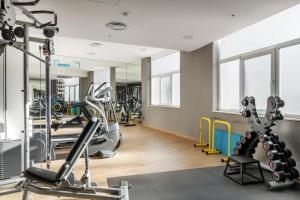 a gym with treadmills and elliptical machines at Apartaments SB Corona Tortosa in Tortosa
