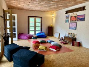 a living room with colorful pillows on the floor at Shambhala centrum in Lúčka