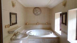 a bathroom with a tub and a sink and a toilet at Shambhala centrum in Lúčka