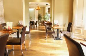 a restaurant with tables and chairs and a dining room at The Dean Court in York