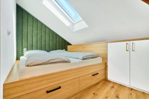 a bedroom with a bed with a green wall at Modrý Janek in Znojmo