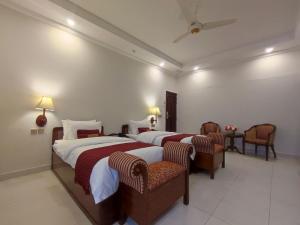 Ένα ή περισσότερα κρεβάτια σε δωμάτιο στο Welcome Guest House Islamabad +15 φωτογραφίες