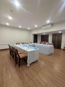 a meeting room with two tables and chairs in a room at Welcome Hotel Islamabad in Islamabad