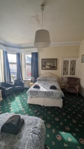 a hotel room with two beds and a large window at Dalgair House Hotel in Callander