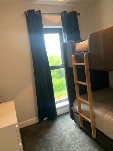 a room with a bunk bed and a window at 3 bedroom barn conversion in the country (Pet Friendly) in Stawell