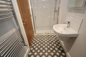 a bathroom with a sink and a toilet and a shower at 3 bedroom barn conversion in the country (Pet Friendly) in Stawell