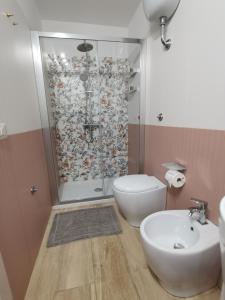 a bathroom with a shower and a toilet and a sink at Casa Marinella in Crotone