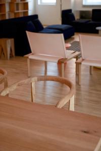 two chairs and a table with a laptop on it at BasicVillage Milano in Milan